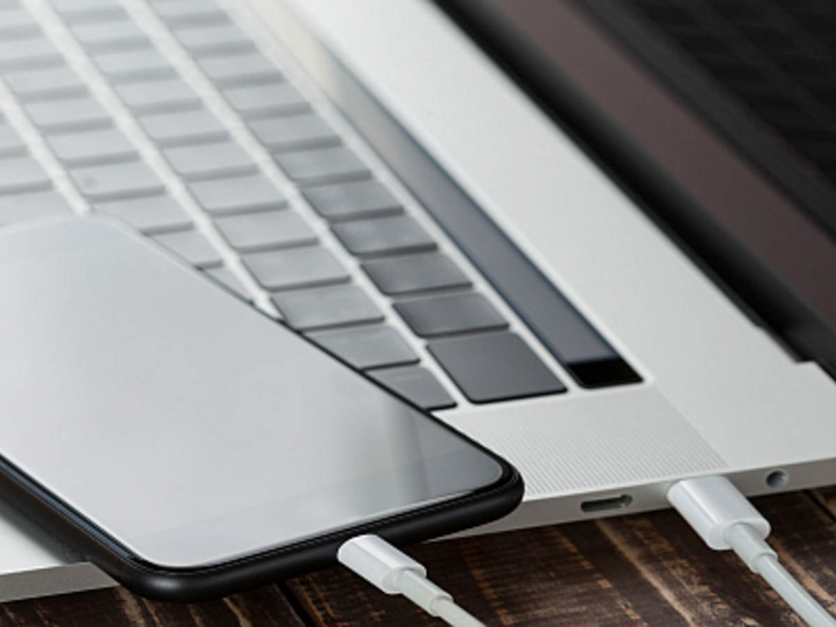 A smartphone using a USB Type-C cable to connect to a laptop.  